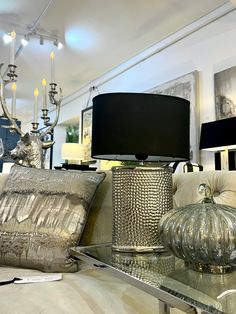 a living room filled with lots of furniture and decor on top of a glass table