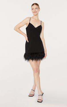 Show off your flattering silhouette in our Cora Dress. Featuring a black fit and flare silhouette with a v-neckline and bow detail, and a mini skirt with a feather hem. Be ready to make a statement in this stunning piece. Fit Details V necklineLinedFit and flare silhouetteMini lengthSleeveless67% Polyester 27% Rayon 6% SpandexDry Clean Only Made in USA Length: 23.5in/59.69cm, from strap seamMeasurements from size 4 Elegant Feathered Mini Dress For Formal Occasions, Elegant Feathered Mini Dress For Cocktail, Chic Mini Dress With Feather Trim, Cocktail Mini Dress With Feather Trim, Elegant Mini Dress With Feathers, Chic Mini Dress With Feathers, Elegant Formal Mini Dress With Feathers, Elegant Cocktail Mini Dress With Feathers, Mini Dress With Feather Trim For Gala