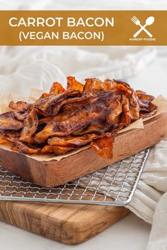 a wooden tray filled with cooked carrots on top of a cooling rack