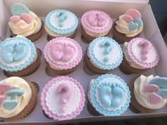 a box filled with cupcakes decorated to look like baby's first year