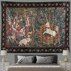 a tapestry hanging on the wall above a bed