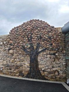 a stone wall with a tree painted on it