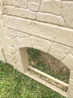 a cement fire place sitting in the grass