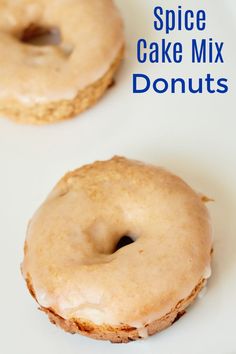 two glazed donuts sitting on top of a white plate with the words spice cake mix doughnuts