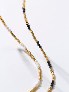 Experience the exquisite beauty of our handcrafted Black Spinel Gold Bean Mini Bead Necklace. Each element is carefully handcrafted to create a refined, elegant look. Add a touch of sophistication to any outfit with this versatile and glamorous necklace. Metal: 18ct Recycled Gold Plated On Brass Gemstone:Black Spinel Pearl: Freshwater Pearl 2.5mm Length: 400-450mm Weight: 5g Elegant Yellow Gold Beaded Necklace, Elegant Gold Pearl Necklace With Tiny Beads, Elegant Gold Beaded Necklace With Tiny Beads, Elegant Pearl Necklace With Tiny Beads, Elegant Pearl Beaded Necklace With Gold Beads, Elegant Pearl Necklace With Gold Beads, Black Spinel Necklace, Black Spinel, Recycled Gold