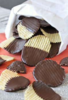 chocolate covered crackers and chips on an orange tablecloth with white paper bag in the background