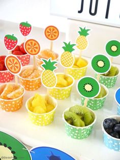 there are many fruit cups on the table