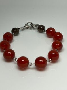 7 Inches- 10mm Red carnelian agate gemstone beads silver tone stainless steel lobster claw closure links bracelet. Hand made jewelry! All purchase will arrive in gift boxes Thanks for stopping by! Red Carnelian Beaded Bracelets, Carnelian Bracelet Jewelry Gift, Elegant Red Carnelian Beaded Bracelets, Red Carnelian Round Bead Jewelry, Red Carnelian Bead Jewelry, Elegant Red Agate Beaded Bracelets, Modern Gemstone Beads Jewelry For Gifts, Modern Gemstone Beads Jewelry Gift, Modern Gemstone Beads Jewelry As Gift