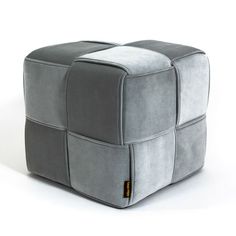 an ottoman made out of grey squares on a white background