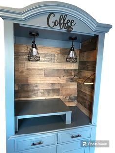 a blue cabinet with two lights on top and some drawers in front of the door