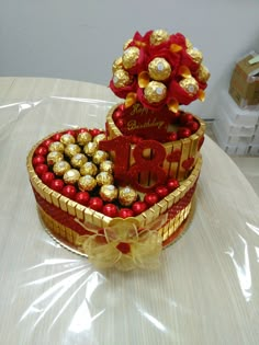 a heart shaped box filled with chocolates on top of a table