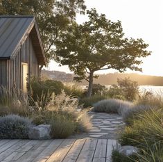 a wooden walkway leading to a house next to water