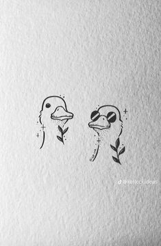 two birds with faces drawn in ink on paper