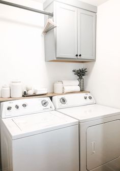 a white washer and dryer sitting next to each other in a laundry room