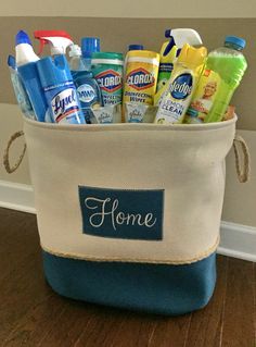 a blue and white bag filled with cleaning products on top of a hard wood floor