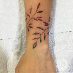 a woman's foot with a tattoo on it