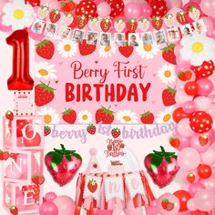 a strawberry themed first birthday party with balloons and decorations