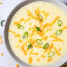 a white bowl filled with cheese and vegetables