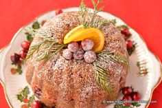 a christmas cake on a plate with orange slices