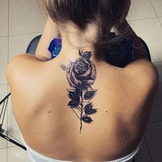 a woman with a rose tattoo on her back