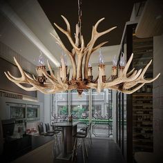 a chandelier made out of antlers in a dining room