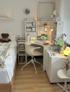 a bed room with a neatly made bed and a desk in front of a window