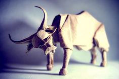 an origami bull is standing on a table