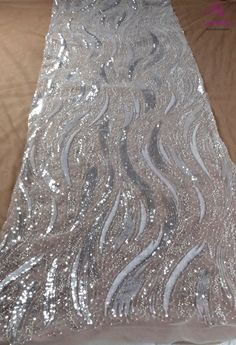 silver sequin fabric on a bed sheet