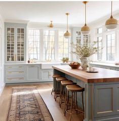 a kitchen with blue cabinets and wooden counter tops