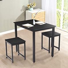 a black table and two chairs in a room