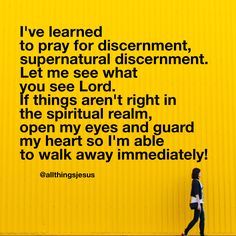 a woman walking past a yellow wall with the words, i've learned to pray for discernment, supernaturalal discrement, let me see what you see what