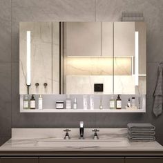 a modern bathroom with marble counter tops and mirrors