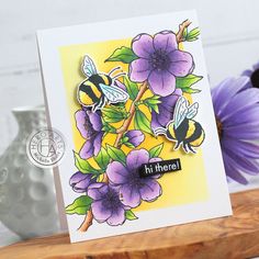 a card with purple flowers and bees on it