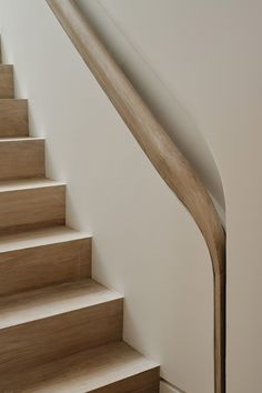 there is a wooden hand rail on the stairs