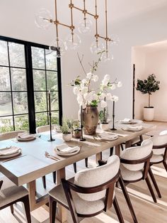 the dining room table is set with white plates and place settings for eight people to eat