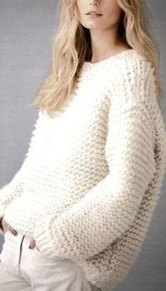 a woman in white sweater posing for a photo