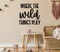 there is a wall sign that says where the wild things play with toys on the floor