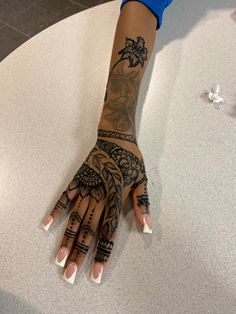 a woman's hand with tattoos on it