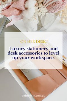 a desk with a laptop, notebook and flowers on it text reads on her desk luxury stationery and desk accessories to level up your workspace