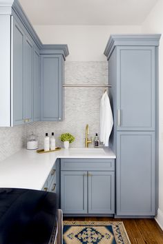 a kitchen with blue cabinets and white counter tops is featured in the instagram page