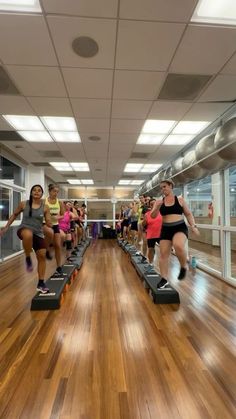 a group of people running on treads in a gym