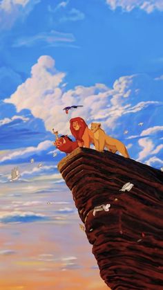 the lion king is sitting on top of a cliff and looking at birds flying around