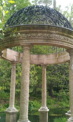 an ornate gazebo in the middle of a park