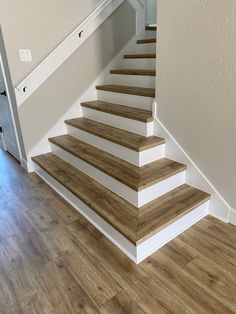 the stairs are made of wood and white paint