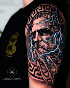 a man with a tattoo on his arm that has lightning coming out of the head