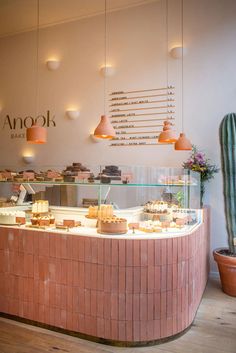 the interior of an open bakery with cakes and pastries on display