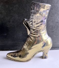 "Cast Iron High Heeled Laced Ladies Boot with A Gilt Finish About 9 5/8\" tall. I can find no makers name or mark. Probably for a Victorian Advertising Shoe/ Boot Promotion. Probably 1920's, some of the plate is flaking- I think it adds to the charm as its not over gaudy. A great doorstop? is heavy We do not alter any items sold; they are listed the way they were found.  We get the dust and dirt off, but all serious cleaning and repairs are the decision of the purchaser We are willing to ship anywhere you are willing to pay to have it shipped there. We will combine shipping and are willing to ship to other countries. If interested in multiple purchases and/or shipping to other countries, we will be happy to quote accurate shipping to your location. We feel that (all) your desires should no Luxury Fitted Vintage Lace-up Boots, Vintage Steel Toe Lace-up Boots, Vintage Leather Ankle-high Lace-up Boots, Vintage Lace-up Boots With Goodyear Welted Construction, Vintage Lace-up Boots With Reinforced Heel, Burlap Art, Oval Picture Frames, Vintage Green Glass, Antique Cast Iron