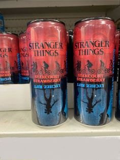 six cans of strange things sit on a shelf in a store for $ 5 each