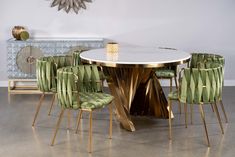 a dining room table with green chairs around it