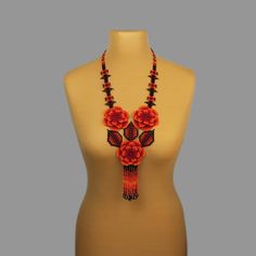 A red flower necklace is a stylish and original decoration. A boho bead necklace will make you more tender and sophisticated. A hippie bead necklace will be a wonderful birthday gift for sister. Despite the size, the seed bead necklace is not heavy.  A flower necklace is suitable for any look and is easily combined with clothes of different styles. All beaded jewelry in our assortment is unique. Each product has its own style and original design. Nevertheless, many pieces of jewelry are easily c Handmade Red Beaded Flower Necklaces, Handmade Red Flower Beaded Necklaces, Elegant Red Beaded Necklace With Black Beads, Elegant Red And Black Beaded Necklaces, Elegant Red And Black Beaded Necklace, Handmade Adjustable Red Flower Necklace, Handmade Red Flower Necklace Adjustable, Handmade Red Flower Necklace With Adjustable Fit, Red Flower Bohemian Necklace